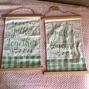 Wall decor with green lettering “Gather Together”